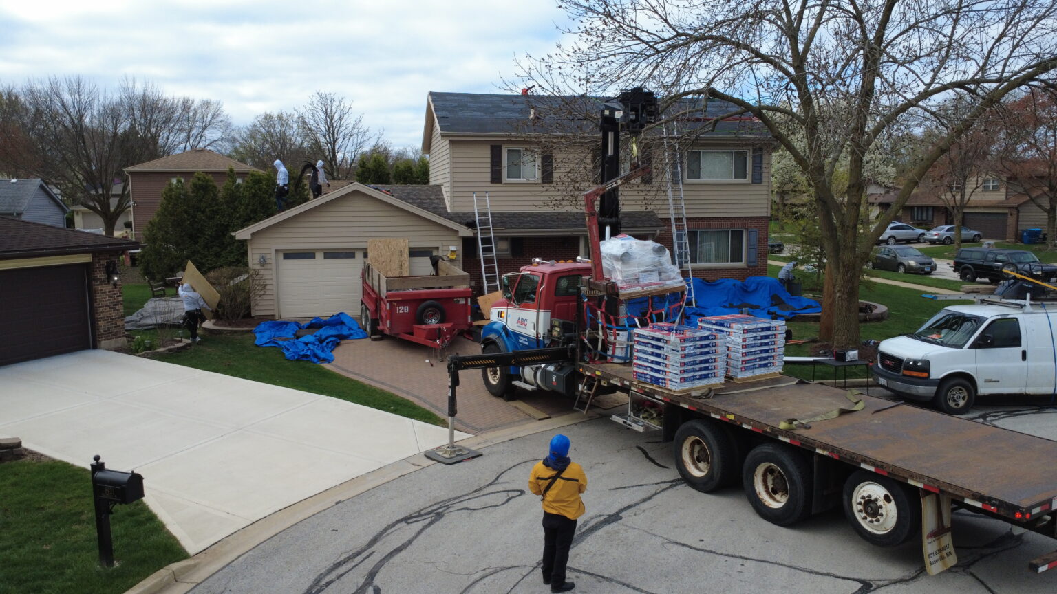 Roofing crew and delivery truck preparing materials to replace your roof in Downers Grove during fall maintenance season.