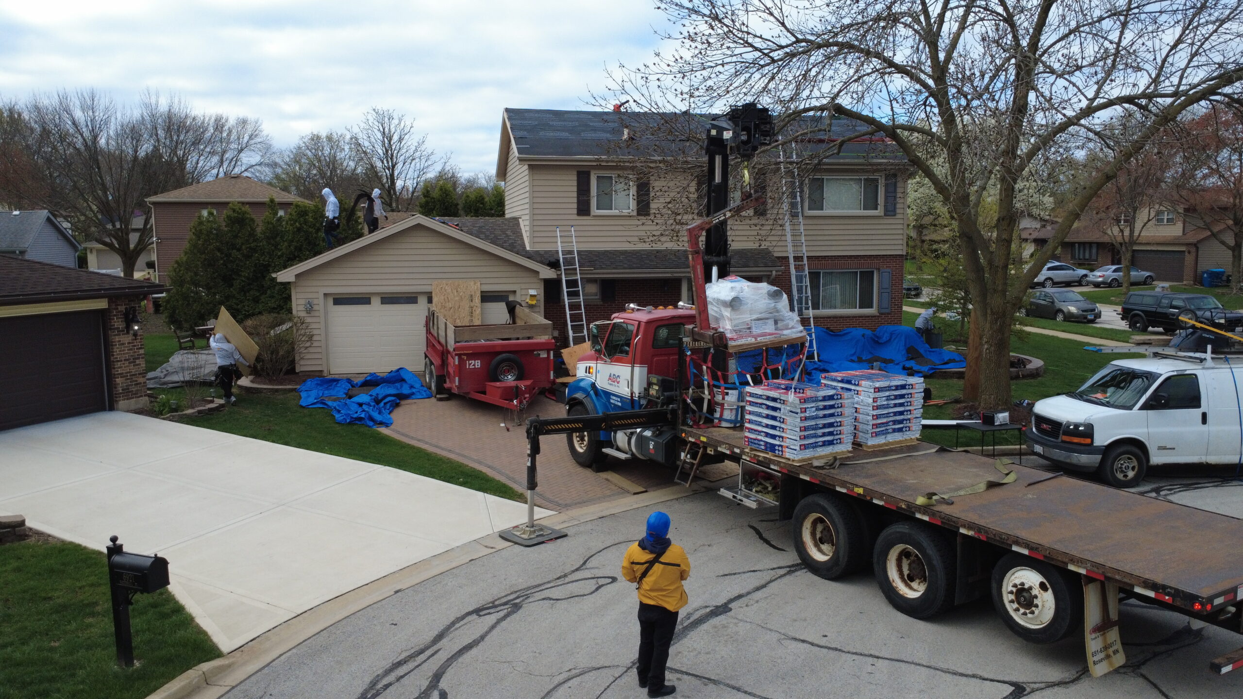 Roofing crew and delivery truck preparing materials to replace your roof in Downers Grove during fall maintenance season.