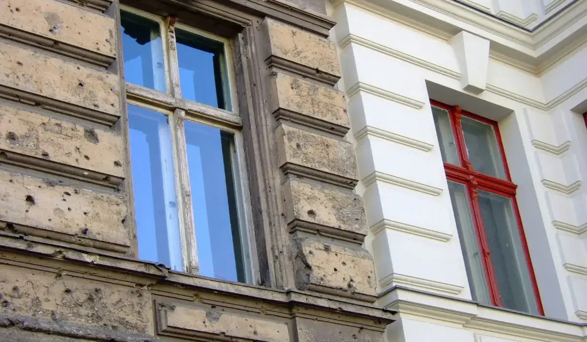 Visible contrast between damaged and restored home exterior, illustrating wear, deterioration, and the need for exterior renovation.