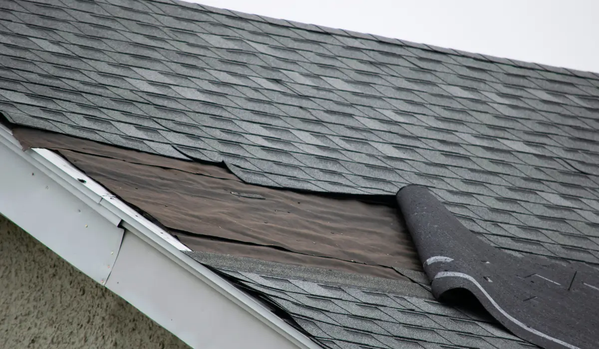 Aerial view of a home in Downers Grove with snow-covered shingles, visible deterioration, and signs the roof needs replacement before winter weather intensifies.