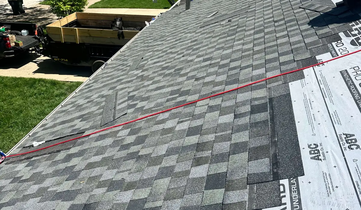 Shingles being installed as part of the Roof Replacement Timeline, showing the stages of residential roof replacement.
