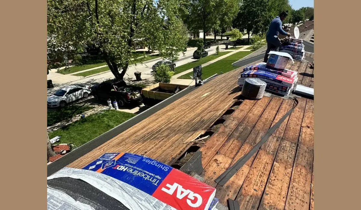 Roofing contractor in Downers Grove installing shingles on residential roof