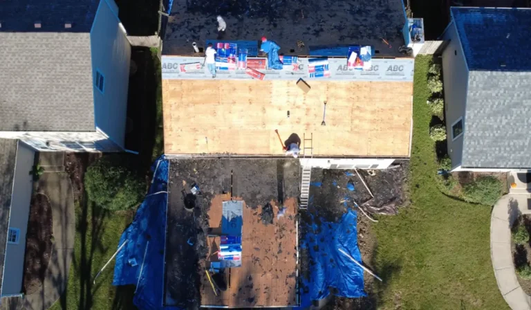 Aerial view of roofing insurance claims work showing storm-damaged roof replacement after professional inspection