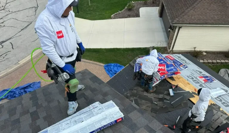 Royal Craft Home Remodelers crew working to repair or replace old roof shingles with new GAF materials in suburban Downers Grove.