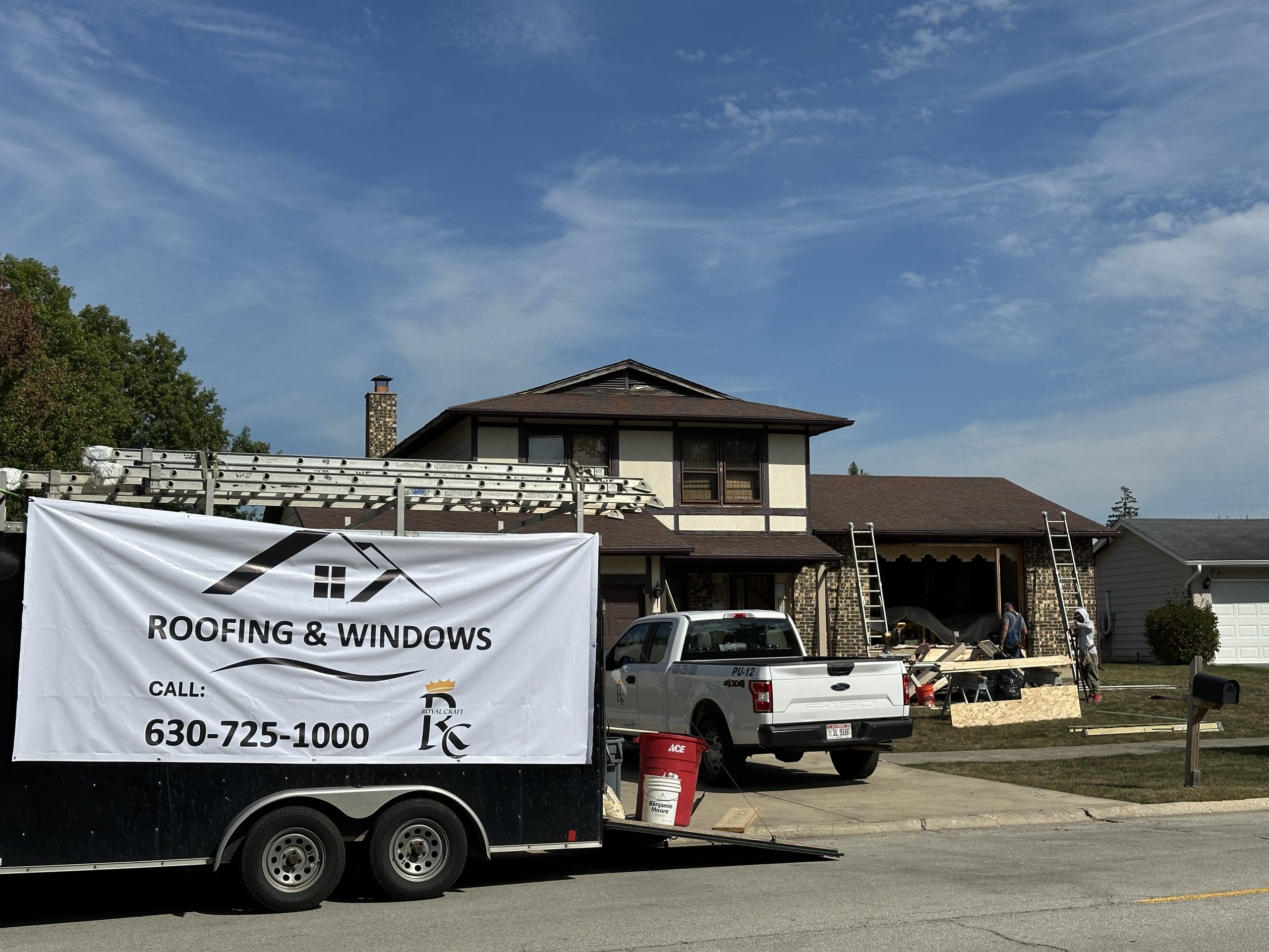 Royal Craft Home Remodelers and windows trailer at a residential window replacement jobsite